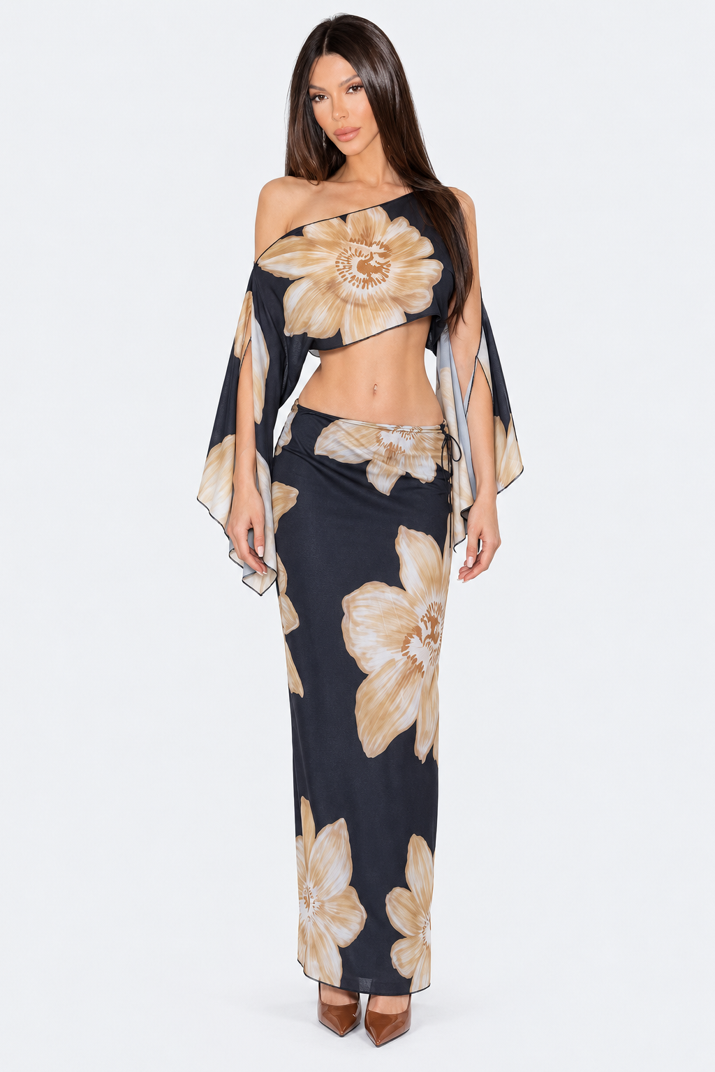 Black and beige floral skirt set with asymmetric crop top and draped split sleeves, front view