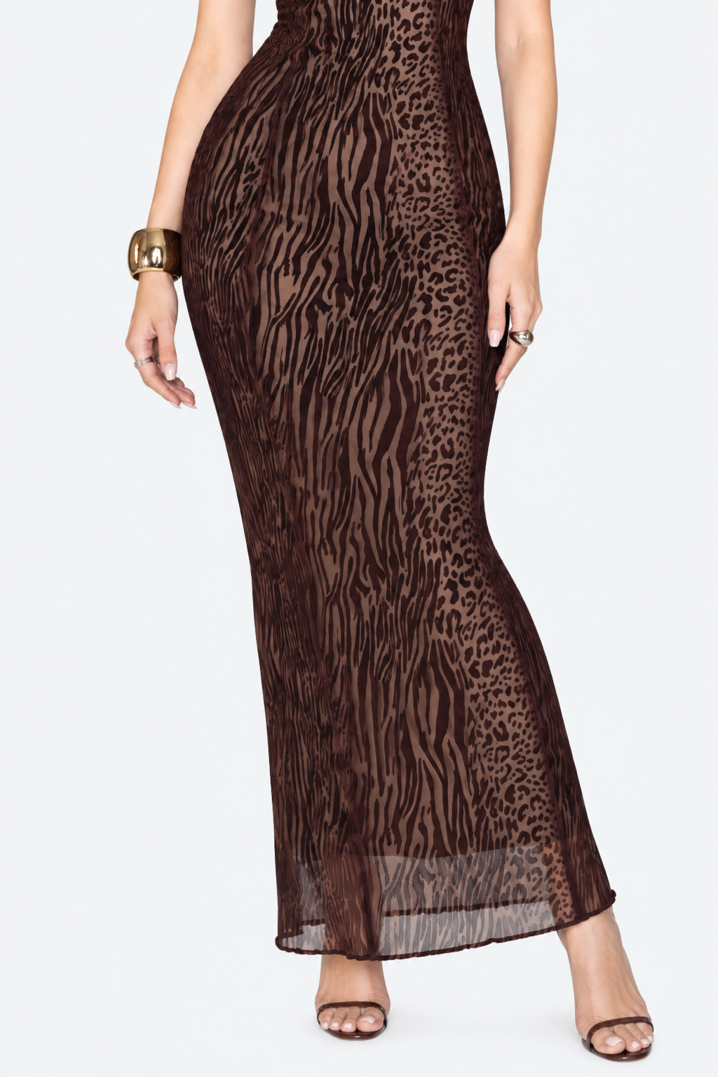 Close-up of the brown animal-print maxi dress showing the fitted skirt and sheer lower hem.
