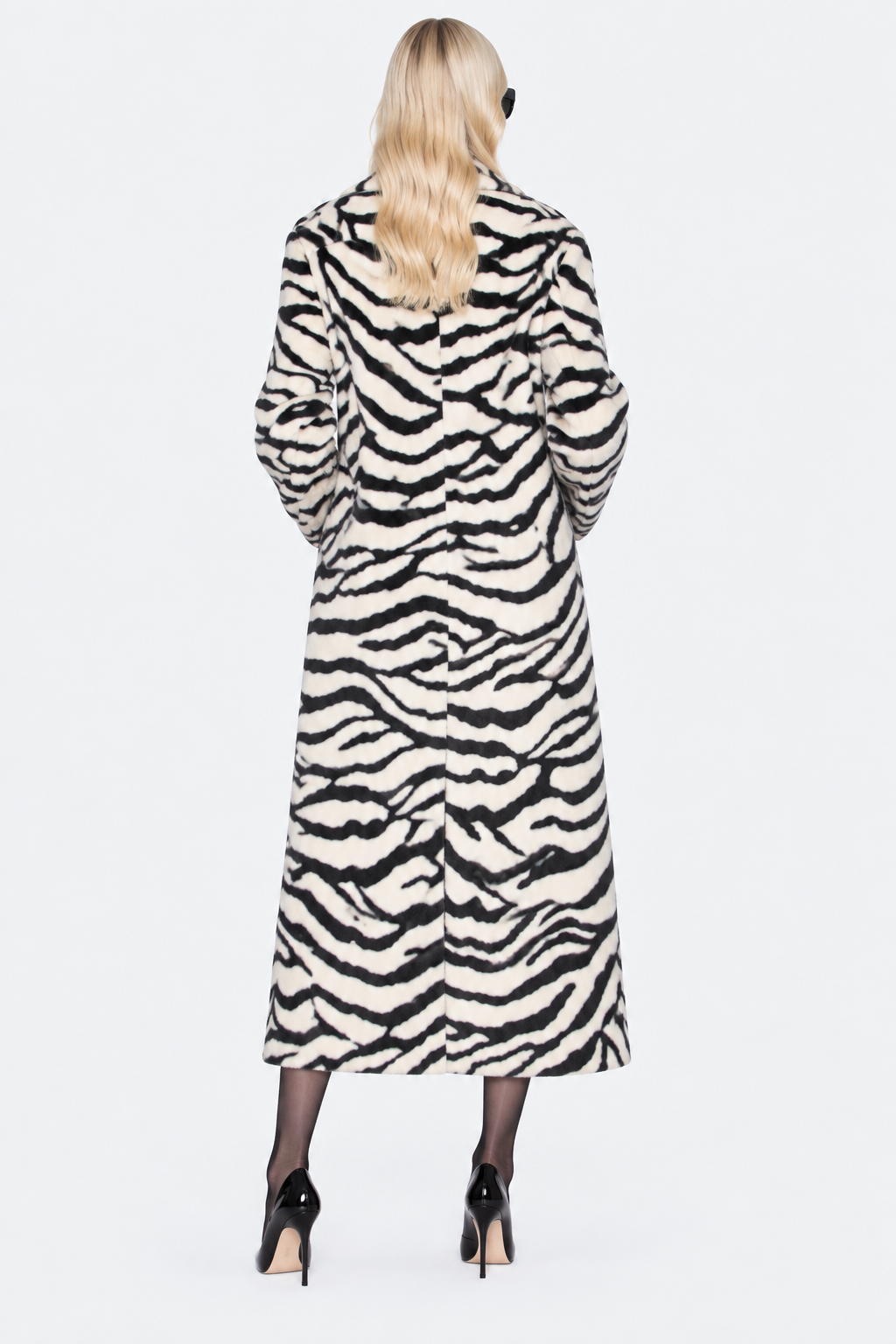 Full-length back view of the black and ivory zebra-print coat showing its long hem and rear vent.
